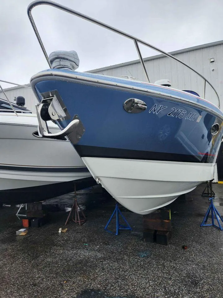 Slide: The Image of 2018 Formula 310 Sun Sport boat on stands in a marina. - 7