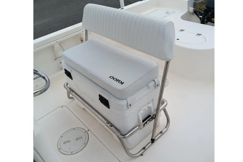 Slide: The Image of 2002 Sea Hunt Navigator 22 boat interior with white cushioned seating and cooler. - 10
