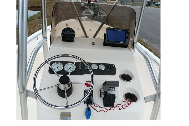 Slide: The Image of 2002 Sea Hunt Navigator 22 boat dashboard with steering wheel and navigation equipment. - 11