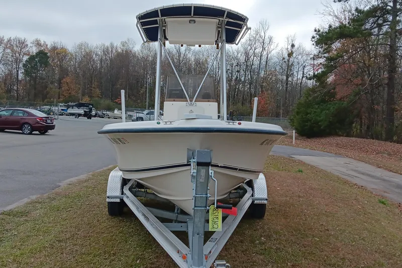 Slide: The Image of 2002 Sea Hunt Navigator 22 boat on trailer in wooded parking area. - 7