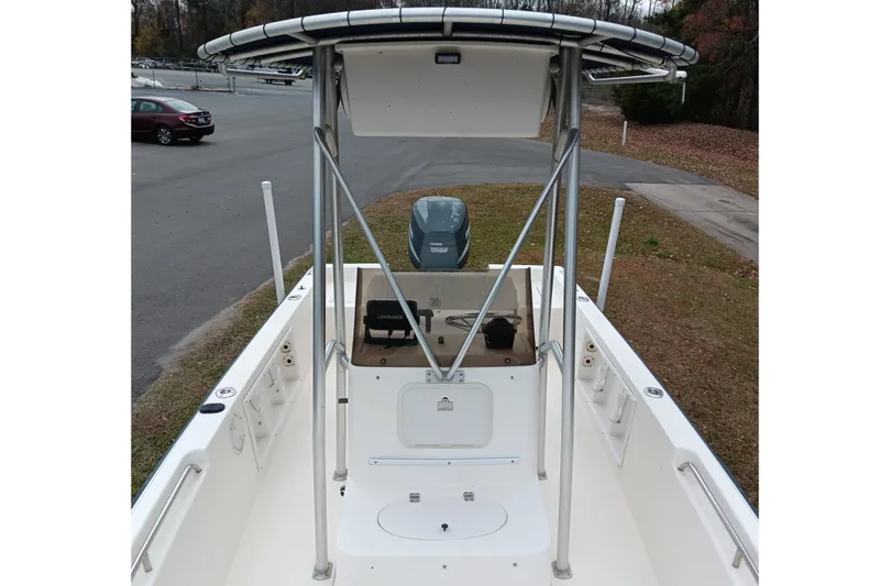 Slide: The Image of 2002 Sea Hunt Navigator 22 boat with T-top and outboard motor in a parking area. - 9