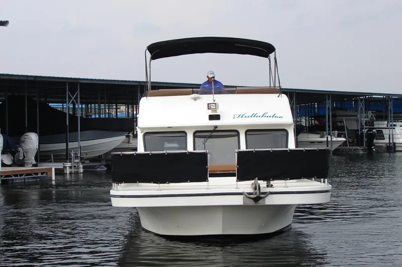 Slide: The Image of 1997 Gibson 47 Sport Houseboat docked at marina, front view. - 18