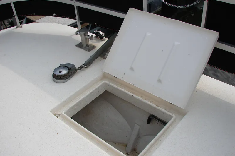 Slide: The Image of Open hatch on 1997 Gibson 47 Sport Houseboat deck, showing storage compartment. - 22