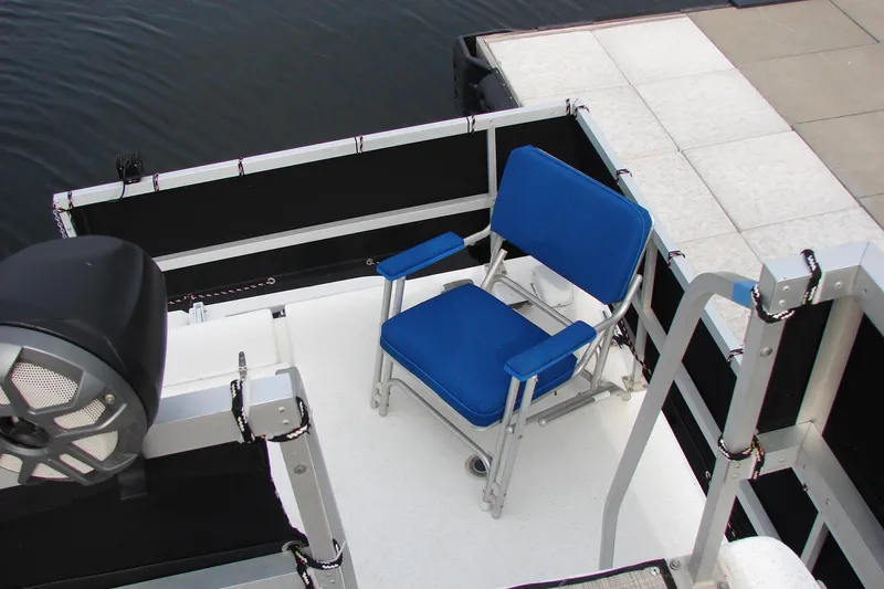 Slide: The Image of 1997 Gibson 47 Sport Houseboat deck with blue chair and speaker. - 28