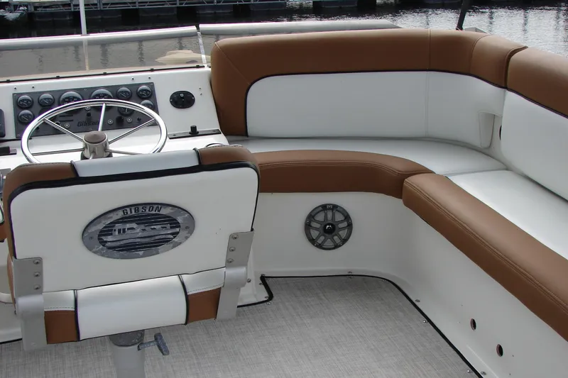 Slide: The Image of 1997 Gibson 47 Sport Houseboat interior with brown and white seating and steering wheel. - 29