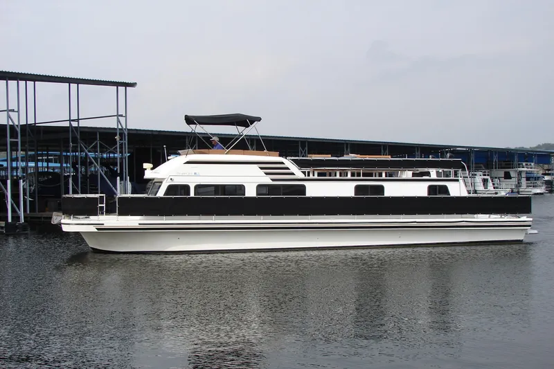 Slide: The Image of 1997 Gibson 47 Sport Houseboat docked at marina, side view. - 3