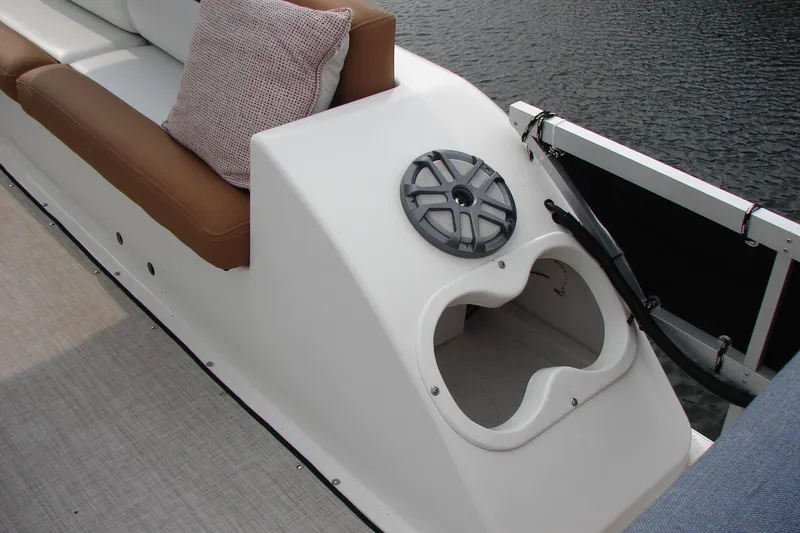 Slide: The Image of 1997 Gibson 47 Sport Houseboat interior with cushioned seating and speaker detail. - 32