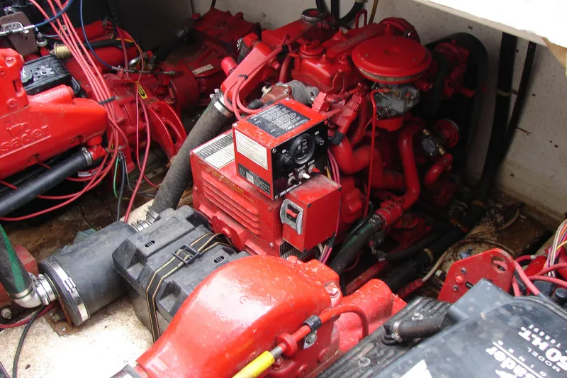 Slide: The Image of Engine compartment of a 1997 Gibson 47 Sport Houseboat with red mechanical components. - 38