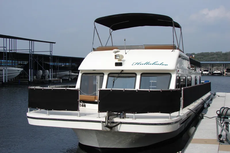 Slide: The Image of 1997 Gibson 47 Sport Houseboat docked at marina, featuring upper deck canopy. - 43