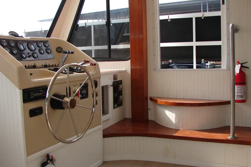 Slide: The Image of Interior helm of 1997 Gibson 47 Sport Houseboat with steering wheel and control panel. - 61