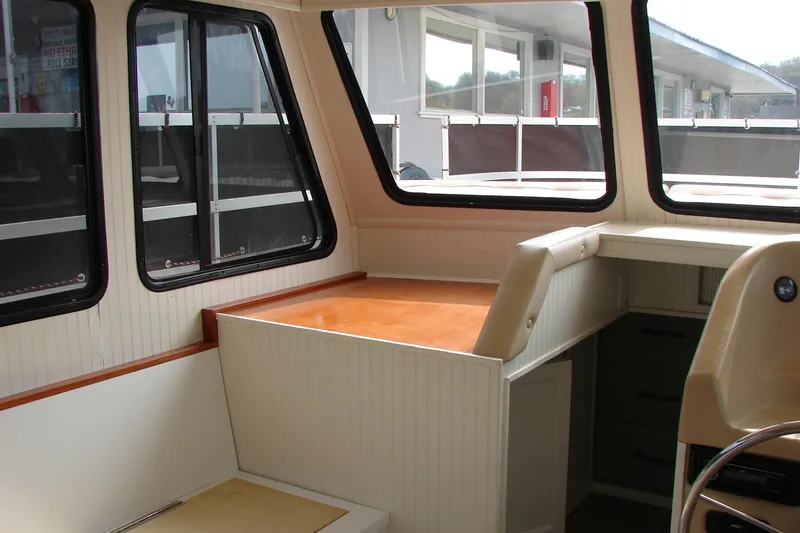 Slide: The Image of Interior of a 1997 Gibson 47 Sport Houseboat with large windows and seating area. - 64