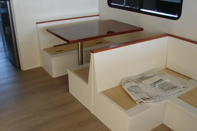 Slide: The Image of 1997 Gibson 47 Sport Houseboat interior with dining area and wooden table. - 65