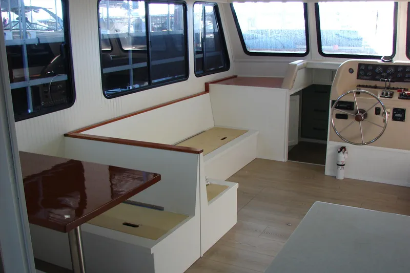 Slide: The Image of Interior of a 1997 Gibson 47 Sport Houseboat with seating and helm. - 66