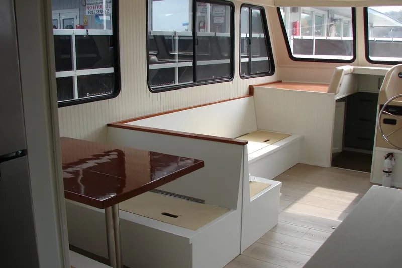 Slide: The Image of Interior of a 1997 Gibson 47 Sport Houseboat with seating and helm. - 68
