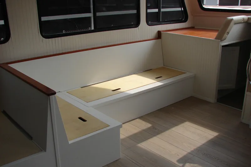Slide: The Image of Interior of 1997 Gibson 47 Sport Houseboat with seating and storage compartments. - 70