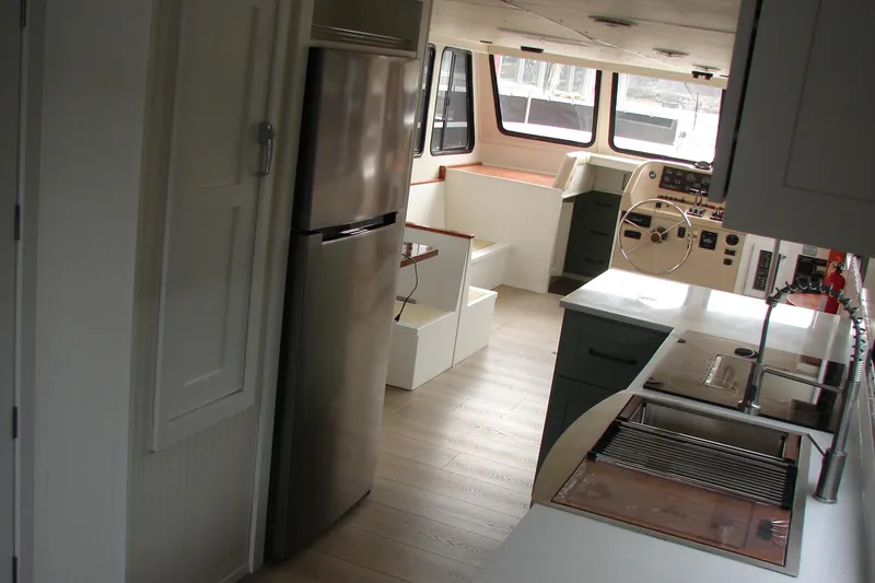 Slide: The Image of Interior of a 1997 Gibson 47 Sport Houseboat with modern kitchen and helm. - 72