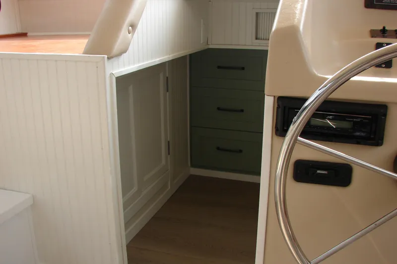 Slide: The Image of Interior of 1997 Gibson 47 Sport Houseboat with steering wheel and cabinetry. - 73