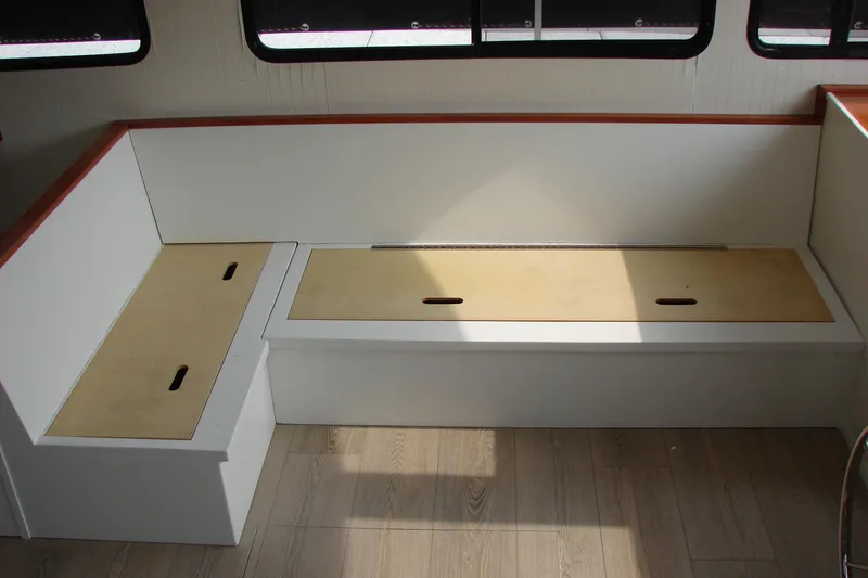 Slide: The Image of Interior seating area of 1997 Gibson 47 Sport Houseboat with storage compartments. - 74