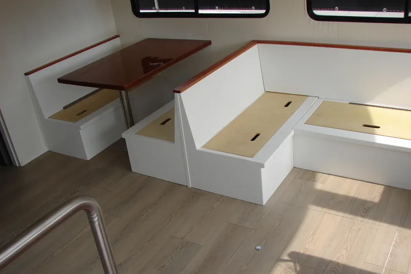 Slide: The Image of Interior of 1997 Gibson 47 Sport Houseboat with wooden table and seating. - 75