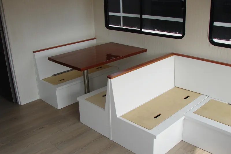 Slide: The Image of Interior of 1997 Gibson 47 Sport Houseboat with dining area and wooden table. - 76