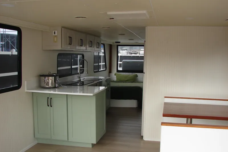 Slide: The Image of Interior of a 1997 Gibson 47 Sport Houseboat with modern kitchen and cozy sleeping area. - 80