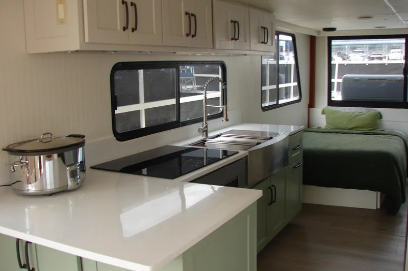 Slide: The Image of Interior of 1997 Gibson 47 Sport Houseboat with modern kitchen and cozy bed. - 81