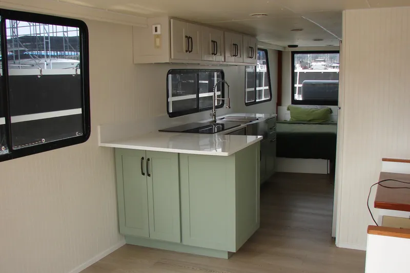 Slide: The Image of Interior of a 1997 Gibson 47 Sport Houseboat with modern kitchen and cozy bedroom. - 82