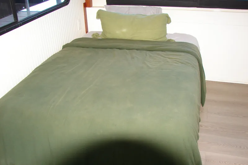 Slide: The Image of Cozy bed with green bedding inside 1997 Gibson 47 Sport Houseboat. - 88