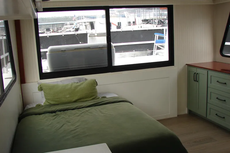Slide: The Image of Interior of 1997 Gibson 47 Sport Houseboat with bed and green cabinetry. - 90