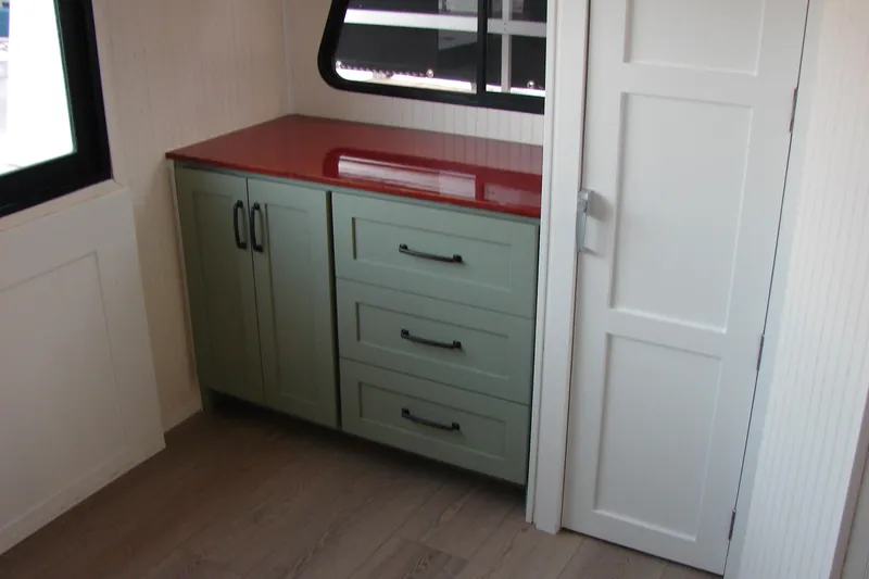 Slide: The Image of Interior of 1997 Gibson 47 Sport Houseboat with green cabinets and red countertop. - 92