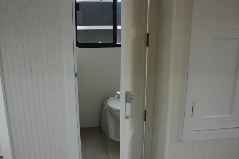 Slide: The Image of Bathroom interior of 1997 Gibson 47 Sport Houseboat with open door and window. - 93