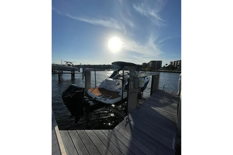 Slide: The Image of 2024 NX Boats NX260 docked at sunset, showcasing sleek design and powerful engine. - 4