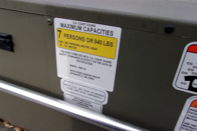 Slide: The Image of 2024 Tracker Grizzly 1860 CC boat capacity label, maximum 7 persons or 950 lbs. - 10