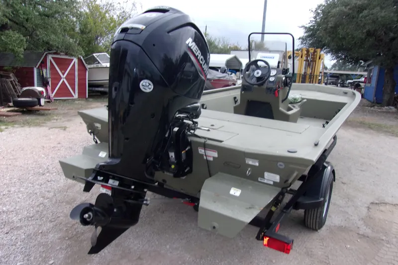 Slide: The Image of 2024 Tracker Grizzly 1860 CC boat with Mercury outboard motor, parked outdoors. - 4