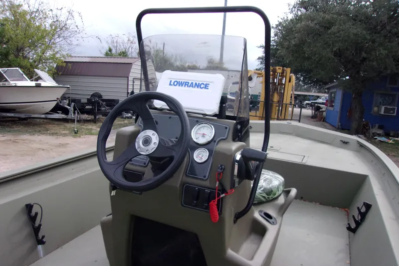 Slide: The Image of 2024 Tracker Grizzly 1860 CC boat interior with steering console and Lowrance equipment. - 5