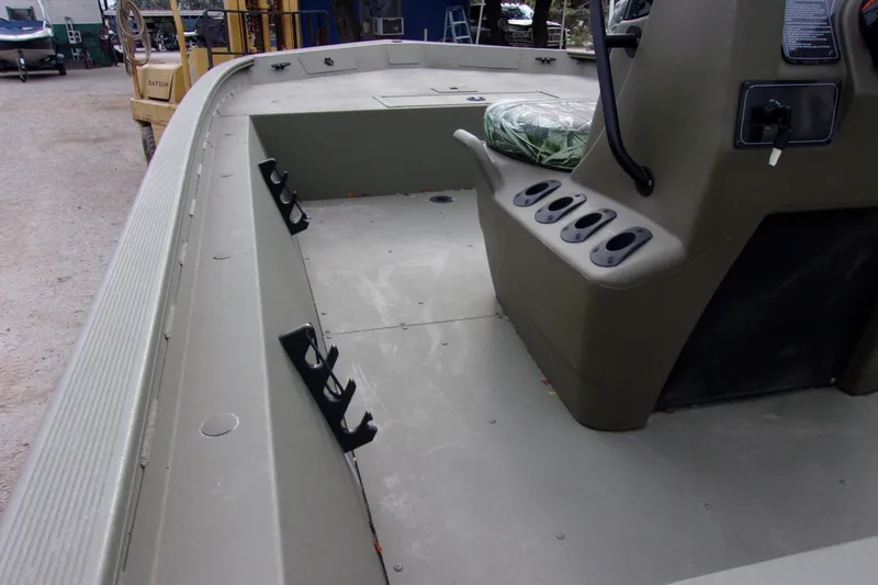 Slide: The Image of 2024 Tracker Grizzly 1860 CC boat interior with rod holders and console. - 7