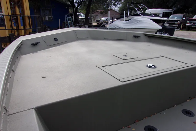 Slide: The Image of 2024 Tracker Grizzly 1860 CC boat deck, featuring storage compartments and cleats. - 9