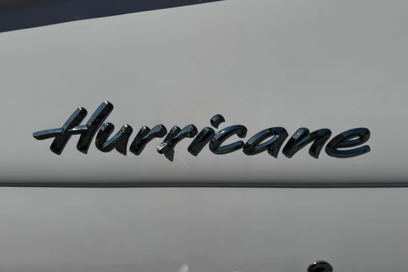 Slide: The Image of 2021 Hurricane SunDeck 2200 DC OB logo on boat exterior. - 13