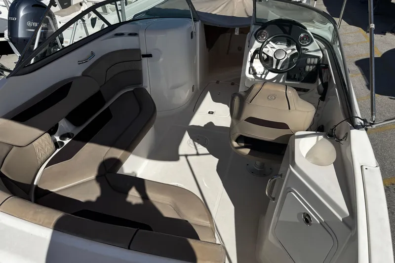 Slide: The Image of 2021 Hurricane SunDeck 2200 DC OB boat interior with seating and steering console. - 17