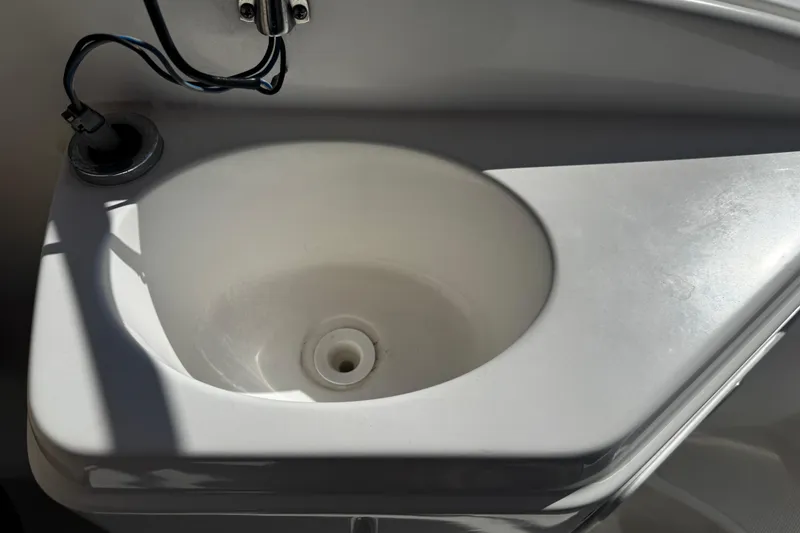 Slide: The Image of 2021 Hurricane SunDeck 2200 DC OB boat sink with faucet and wiring. - 18