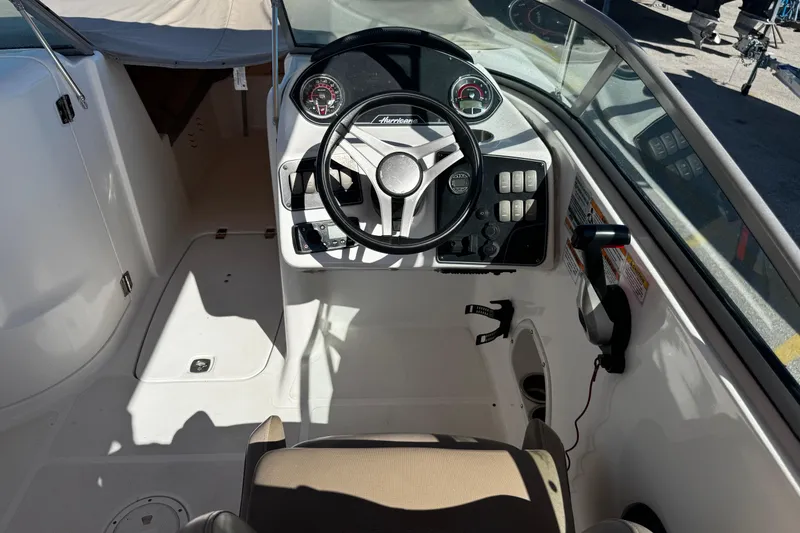 Slide: The Image of 2021 Hurricane SunDeck 2200 DC OB boat cockpit with steering wheel and control panel. - 20