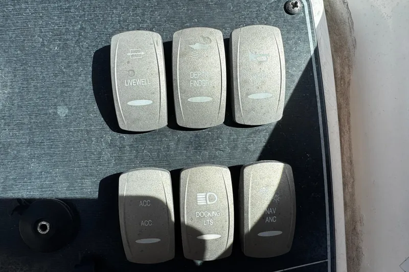 Slide: The Image of Control panel of a 2021 Hurricane SunDeck 2200 DC OB boat with labeled switches. - 21