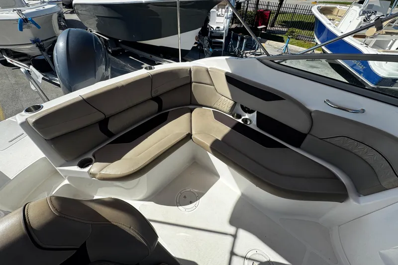 Slide: The Image of 2021 Hurricane SunDeck 2200 DC OB boat interior with cushioned seating and cup holders. - 25