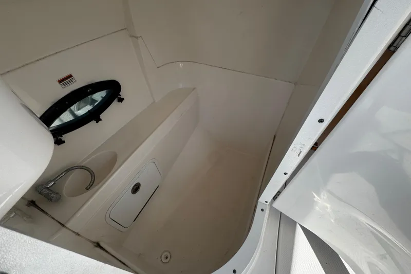 Slide: The Image of 2021 Hurricane SunDeck 2200 DC OB boat interior with sink and porthole. - 26
