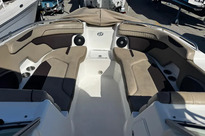 Slide: The Image of 2021 Hurricane SunDeck 2200 DC OB boat interior with cushioned seating and cup holders. - 27