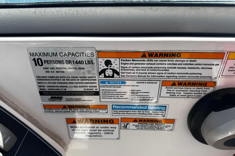 Slide: The Image of Warning labels and capacity information on a 2021 Hurricane SunDeck 2200 DC OB boat. - 31