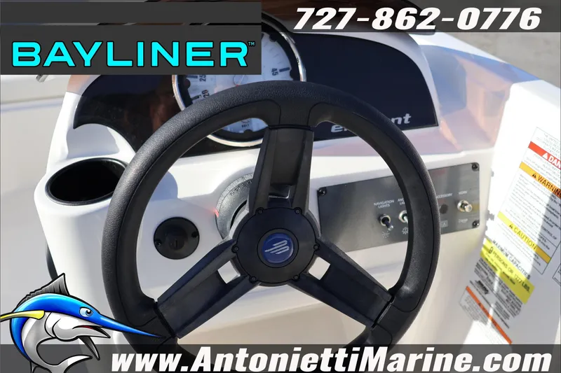 Slide: The Image of 2025 Bayliner Element E18 steering wheel and dashboard, featuring controls and branding. - 15