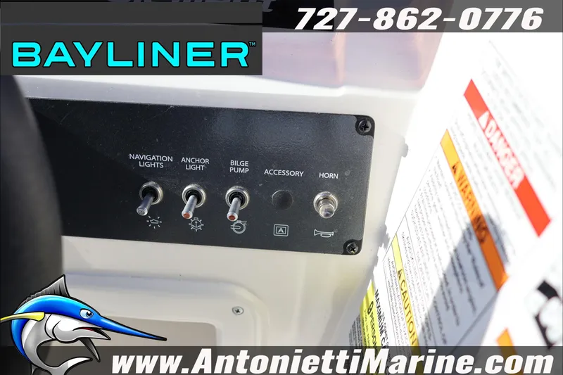 Slide: The Image of Control panel of 2025 Bayliner Element E18 boat with switches and warning labels. - 17
