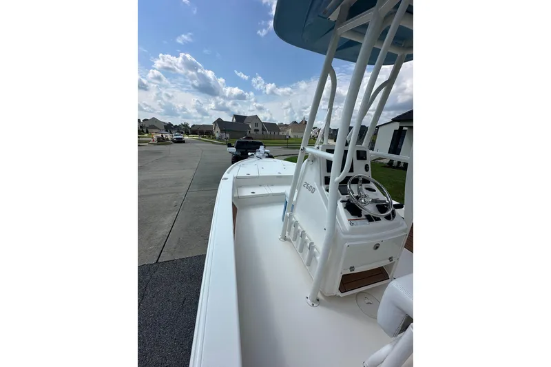 Slide: The Image of 2021 Pathfinder 2500 Hybrid boat on a residential street under a partly cloudy sky. - 11