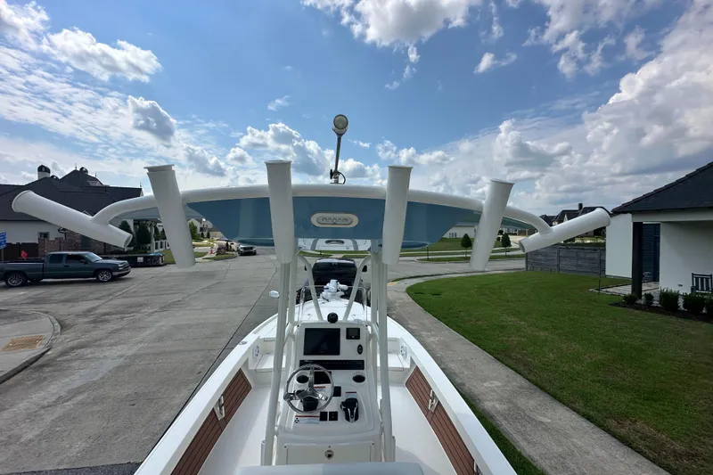 Slide: The Image of 2021 Pathfinder 2500 Hybrid boat with T-top, parked in a suburban neighborhood. - 15